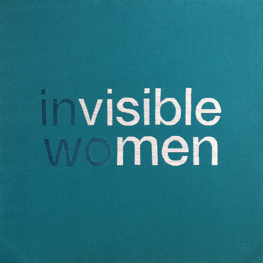 invisible women embroidered on a teal cotton canvas. "in" and "wo" are in teal while "visible" and "men" are white showing the message "visible men" in highlight.